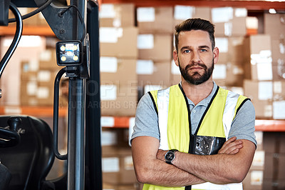 Buy stock photo Cropped portrait of a handsome young male warehouse worker standing with his arms crossed