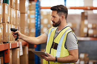 Buy stock photo Cropped shot of a handsome young male warehouse worker checking stock