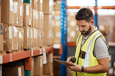 Buy stock photo Cropped shot of a handsome young male warehouse worker checking stock