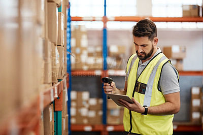 Buy stock photo Cropped shot of a handsome young male warehouse worker checking stock