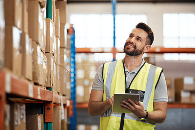 Buy stock photo Cropped shot of a handsome young male warehouse worker checking stock