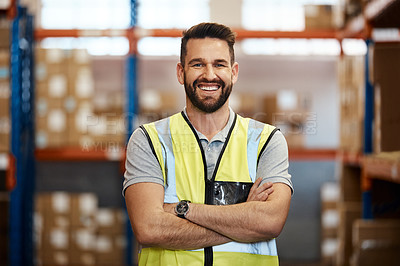 Buy stock photo Cropped portrait of a handsome young male warehouse worker standing with his arms crossed