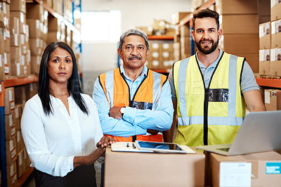 Buy stock photo Cropped portrait of three warehouse workers checking on distribution logistics