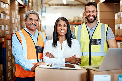 Buy stock photo Cropped portrait of three warehouse workers checking on distribution logistics