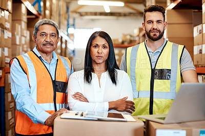 Buy stock photo Cropped portrait of three warehouse workers checking on distribution logistics