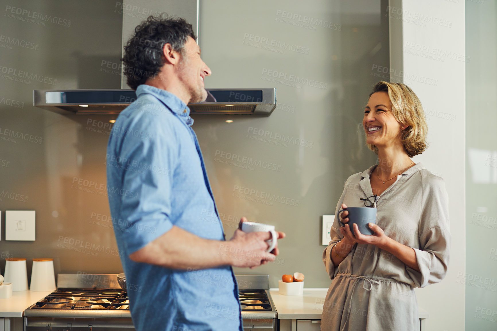 Buy stock photo Couple, kitchen and smile with coffee for morning, chat or gossip together in home. Mature man, woman and happy with connection for conversation, communication and bonding with drink in house