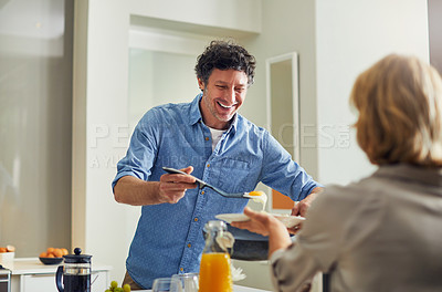 Buy stock photo Shot of a mature man preparing breakfast for him and his wife at home