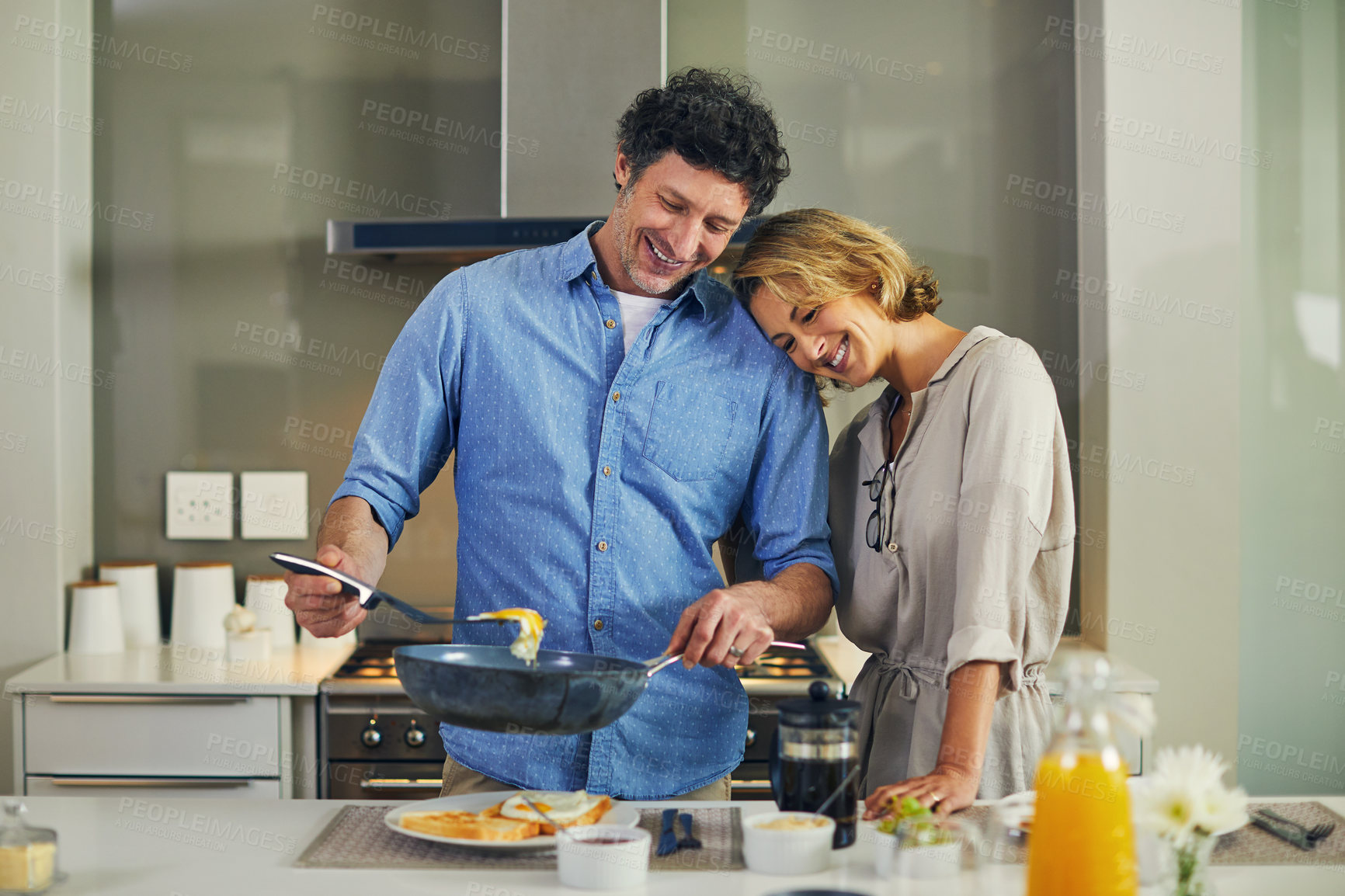 Buy stock photo Shot of a mature man preparing breakfast for him and his wife at home