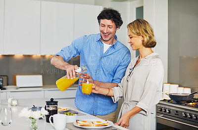Buy stock photo Shot of a mature couple preparing breakfast together at home