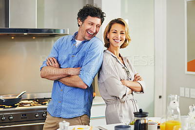 Buy stock photo Portrait of a confident mature couple preparing breakfast together at home