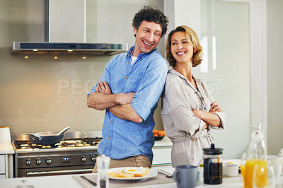 Buy stock photo Portrait of a confident mature couple preparing breakfast together at home