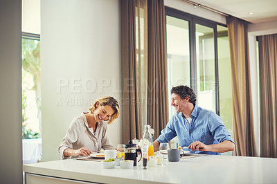 Buy stock photo Shot of a mature couple having a leisurely breakfast together at home