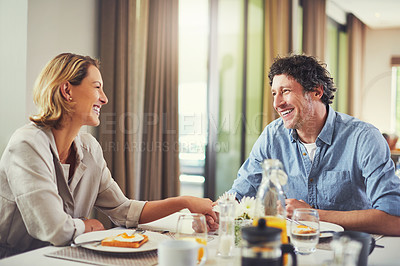 Buy stock photo Shot of a mature couple having a leisurely breakfast together at home