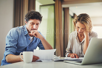 Buy stock photo Shot of a mature couple going over their finances at home
