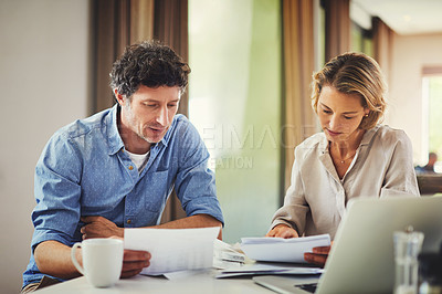 Buy stock photo Shot of a mature couple going over their finances at home