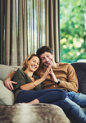 Buy stock photo Shot of an affectionate mature couple relaxing on the sofa at home