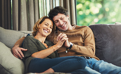 Buy stock photo Shot of an affectionate mature couple relaxing on the sofa at home