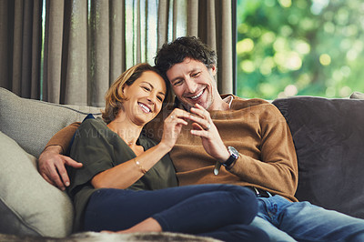 Buy stock photo Shot of an affectionate mature couple relaxing on the sofa at home