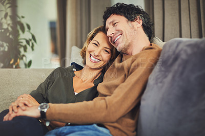 Buy stock photo Shot of an affectionate mature couple relaxing on the sofa at home