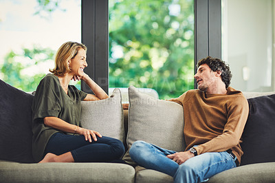 Buy stock photo Shot of a mature couple relaxing and chatting on the sofa at home