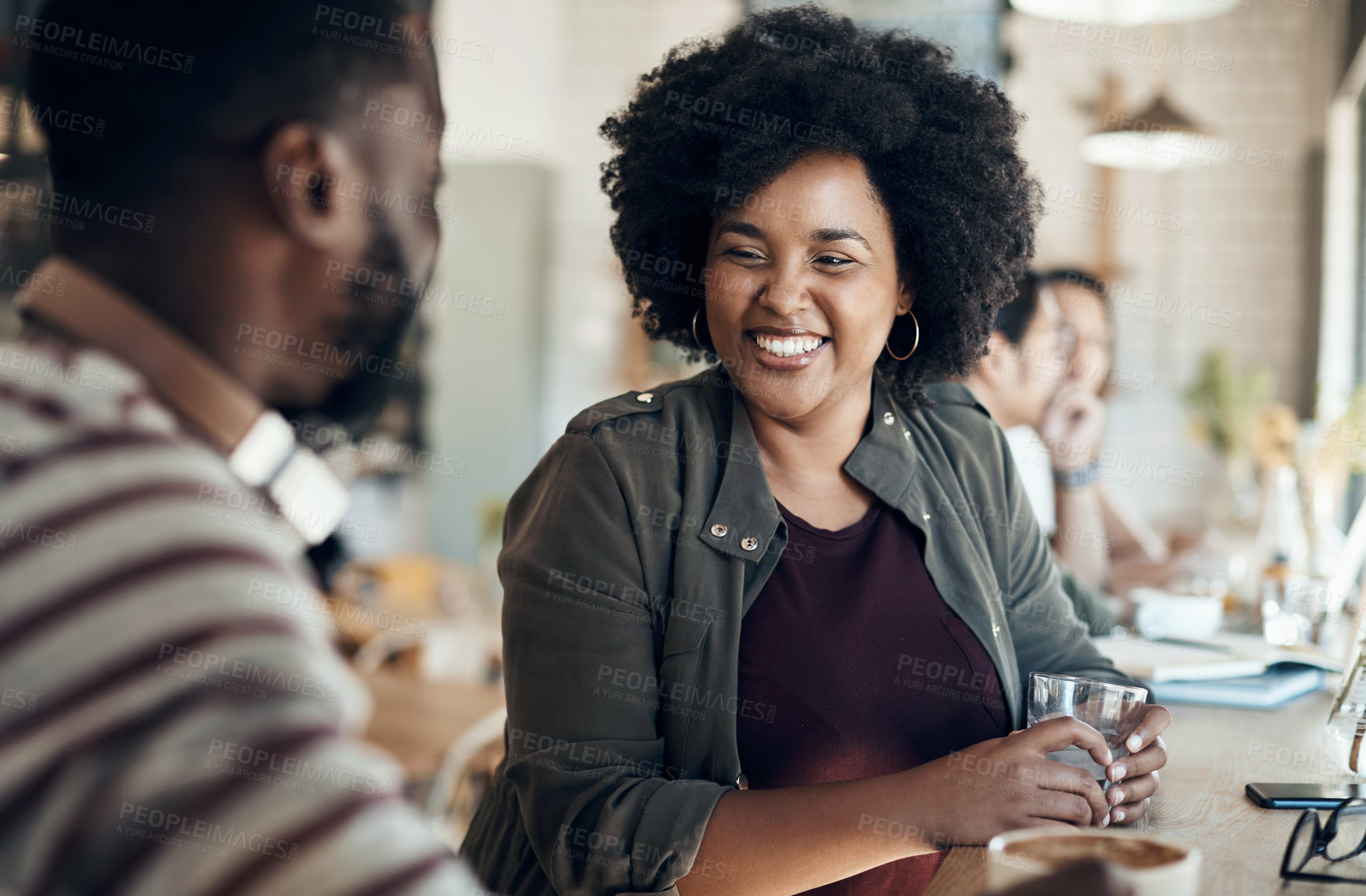 Buy stock photo Cropped shot of an attractive young woman sitting with a male friend in a cafe during the day