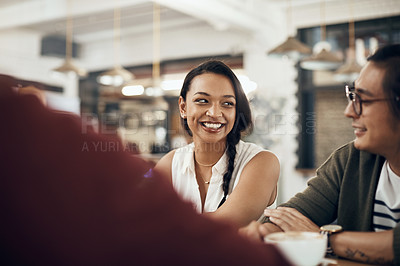 Buy stock photo Cropped shot of a young diverse group of friends sitting together and enjoying coffee in a cafe during the day