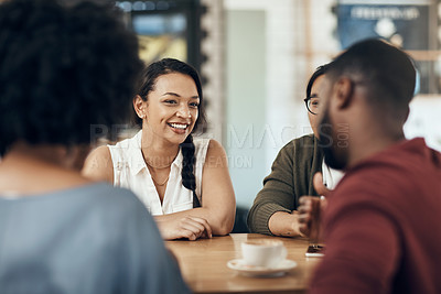 Buy stock photo Cropped shot of a young diverse group of friends sitting together and enjoying coffee in a cafe during the day