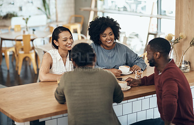 Buy stock photo Cropped shot of a young diverse group of friends sitting together and enjoying coffee in a cafe during the day
