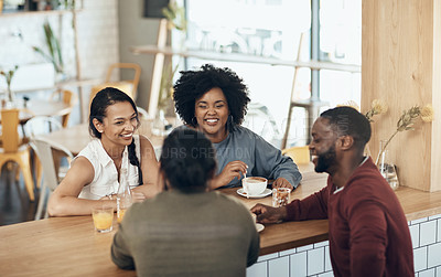 Buy stock photo Cropped shot of a young diverse group of friends sitting together and enjoying coffee in a cafe during the day