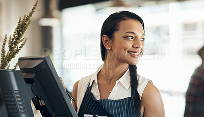Buy stock photo Cropped shot of an attractive young waitress standing behind a till during her shift in a cafe