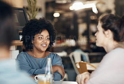 Buy stock photo Cropped shot of two attractive young women sitting together and bonding at a cafe during the day
