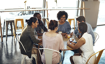 Buy stock photo Cropped shot of a diverse group of friends sitting together and bonding in a coffee shop