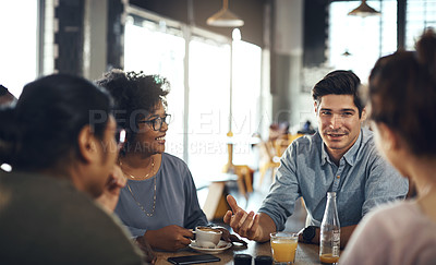 Buy stock photo Cropped shot of a diverse group of businesspeople sitting together and having a discussion in a coffee shop