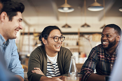 Buy stock photo Cropped shot of a diverse group of friends sitting together and bonding in a coffee shop