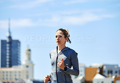 Buy stock photo Cropped shot of a beautiful young woman out for a run in the city