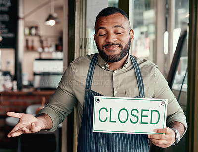 Buy stock photo Shot of a young man shrugging while holding a 