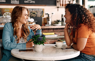Buy stock photo Shot of two young women chatting in a cafe