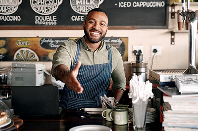 Buy stock photo Portrait of a young man extending a handshake while working in a cafe