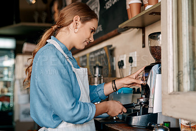 Buy stock photo Shot of a barista preparing coffee in a cafe