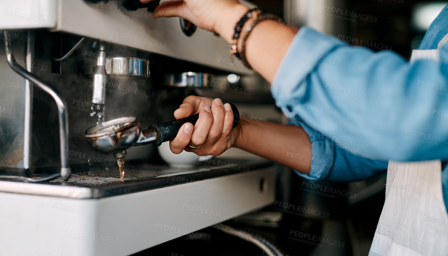 Buy stock photo Closeup shot of a barista preparing coffee in a cafe