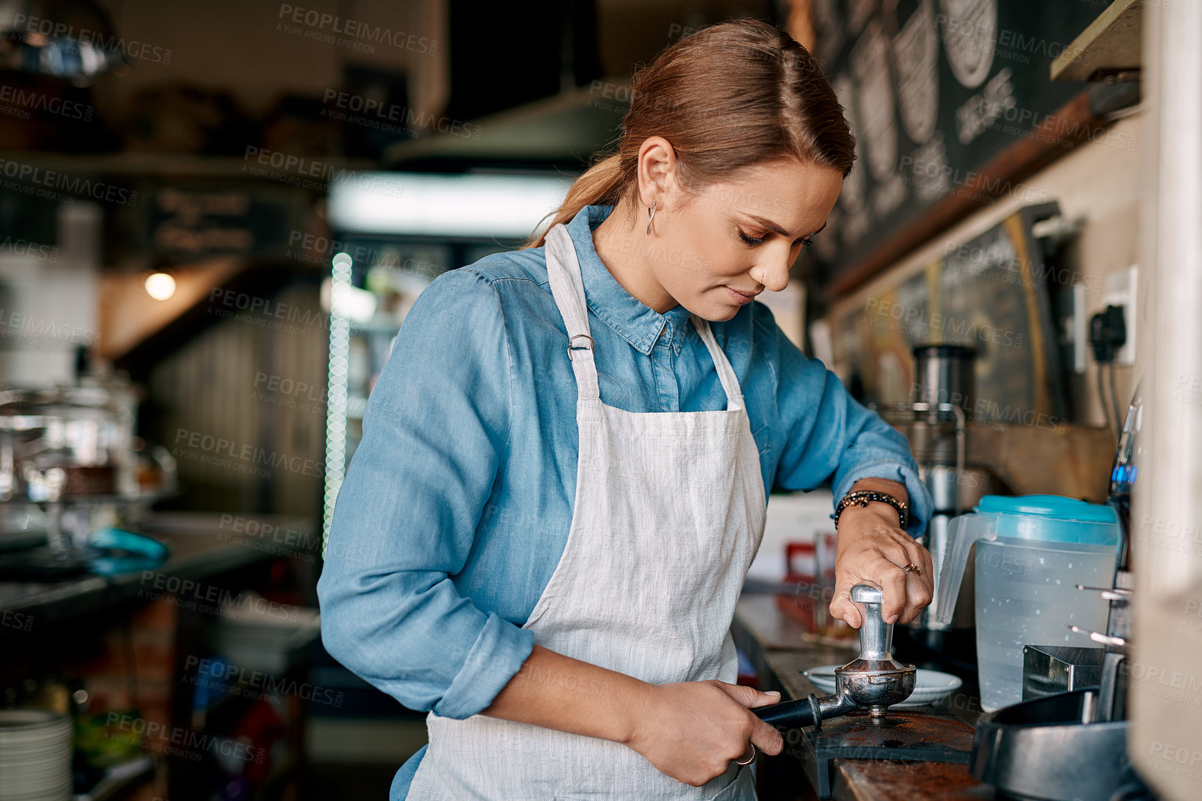 Buy stock photo Shot of a barista preparing coffee in a cafe