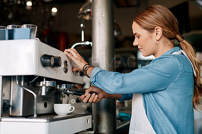 Buy stock photo Shot of a barista preparing coffee in a cafe