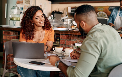 Buy stock photo Shot of a young man and woman having a meeting in a cafe