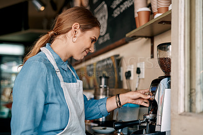 Buy stock photo Shot of a barista preparing coffee in a cafe