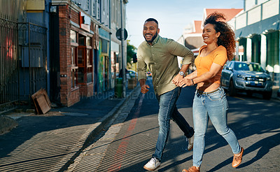 Buy stock photo Shot of a young couple walking together in the city