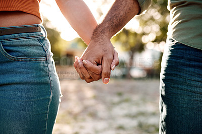 Buy stock photo Closeup shot of an unrecognisable couple holding hands outdoors