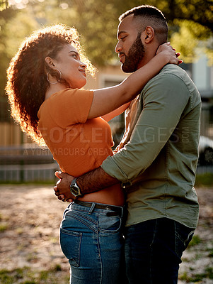 Buy stock photo Shot of an affectionate young couple spending time together outdoors