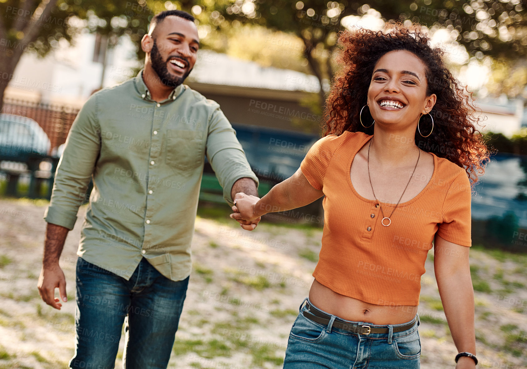 Buy stock photo Shot of a young couple walking together in a park