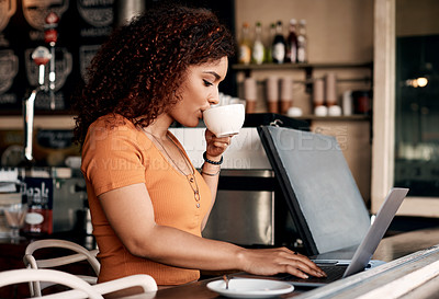 Buy stock photo Shot of a young woman working on a laptop in a cafe