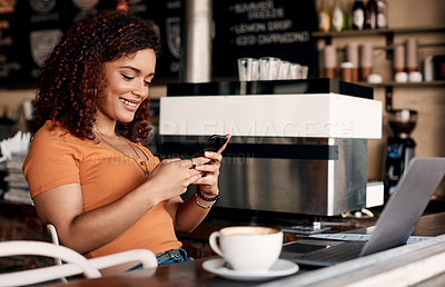 Buy stock photo Shot of a young woman using a cellphone in a cafe